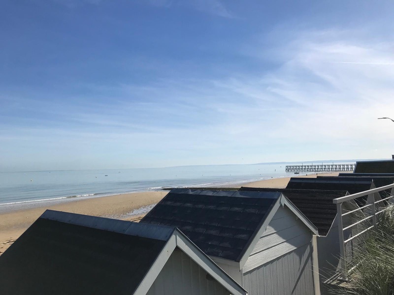 Cabines de plage et ponton au loin